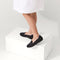hover | The Kids slip-on Loafer in Black Solid shown on-model at an angle.