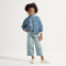 model | An alternate image of a child modeling The Kids Strap Sneaker in Vanilla Ice. 