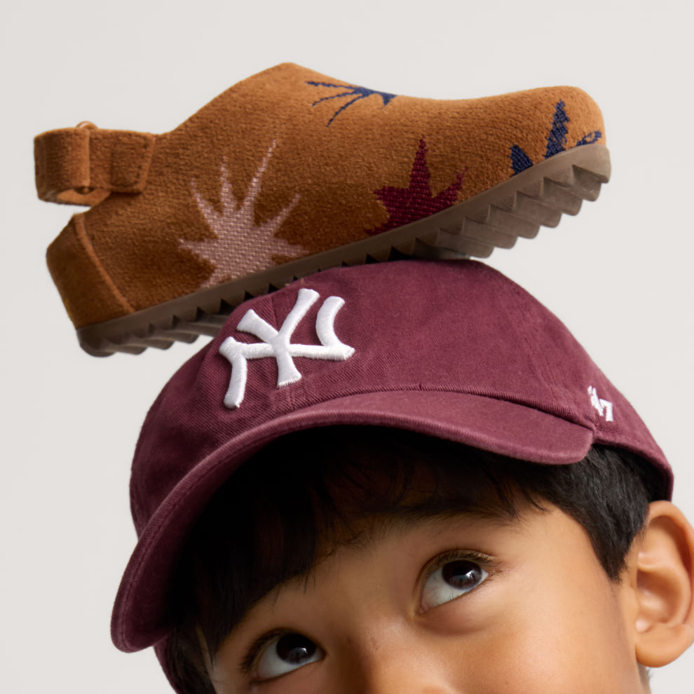 Child with The Kids Clog in ReVelvet Fuchsia Burst on his head. 