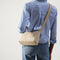 hover | The Casual Crossbody in Parchment, worn as a crossbody by a model, shown from the front. 