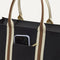 A closeup of The Classic Tote in Black Coffee, focusing on the exterior zip pocket.