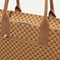 A closeup of The Classic Tote in Hazelnut, focusing on the exterior zip pocket. 