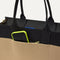 A closeup of The Classic Tote in Tiramisu, focusing on the exterior zip pocket. 