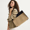 hover | The Classic Tote in Tiramisu, worn over the shoulder by a model, shown from the side.