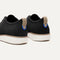 Close up of the heel of The Oxford in Black, with Rothy's signature blue halo. 
