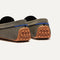Close up of the heel of The Daily Driver in Classic Micro Check, with raised peg outsoles and Rothy's signature blue halo. 