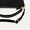 The Daily Crossbody in Revelvet™ Black lying flat, showing the detachable top handle and adjustable crossbody strap.