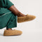 hover | Model wearing The Teddy Kids Slipper in Wren.