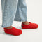 hover | A child wearing The Kids Clog in Firetruck Red. 