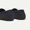 Close up of the heel of The Men's Driver in Carbon Herringbone, with raised peg outsoles and Rothy's signature blue halo. 