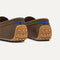 Close up of the heel of The Men's Driver in Dark Roast, with raised peg outsoles and Rothy's signature blue halo. 