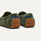 Close up of the heel of The Men's Driver in Forest Camo, with raised peg outsoles and Rothy's signature blue halo. 
