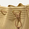 A close up of The Cinch Bucket Bag in Brown Butter Crochet showing the drawstring closure.