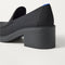 Close up of the heel of The Block Heel Loafer in Black, with Rothy's signature blue halo. 