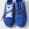 Overlay:: Extra pair of laces included—swap for a new look anytime. | Alt: Close up of the top of The Ivy Sneaker in ReVelvet Cobalt, showing different lace choices.