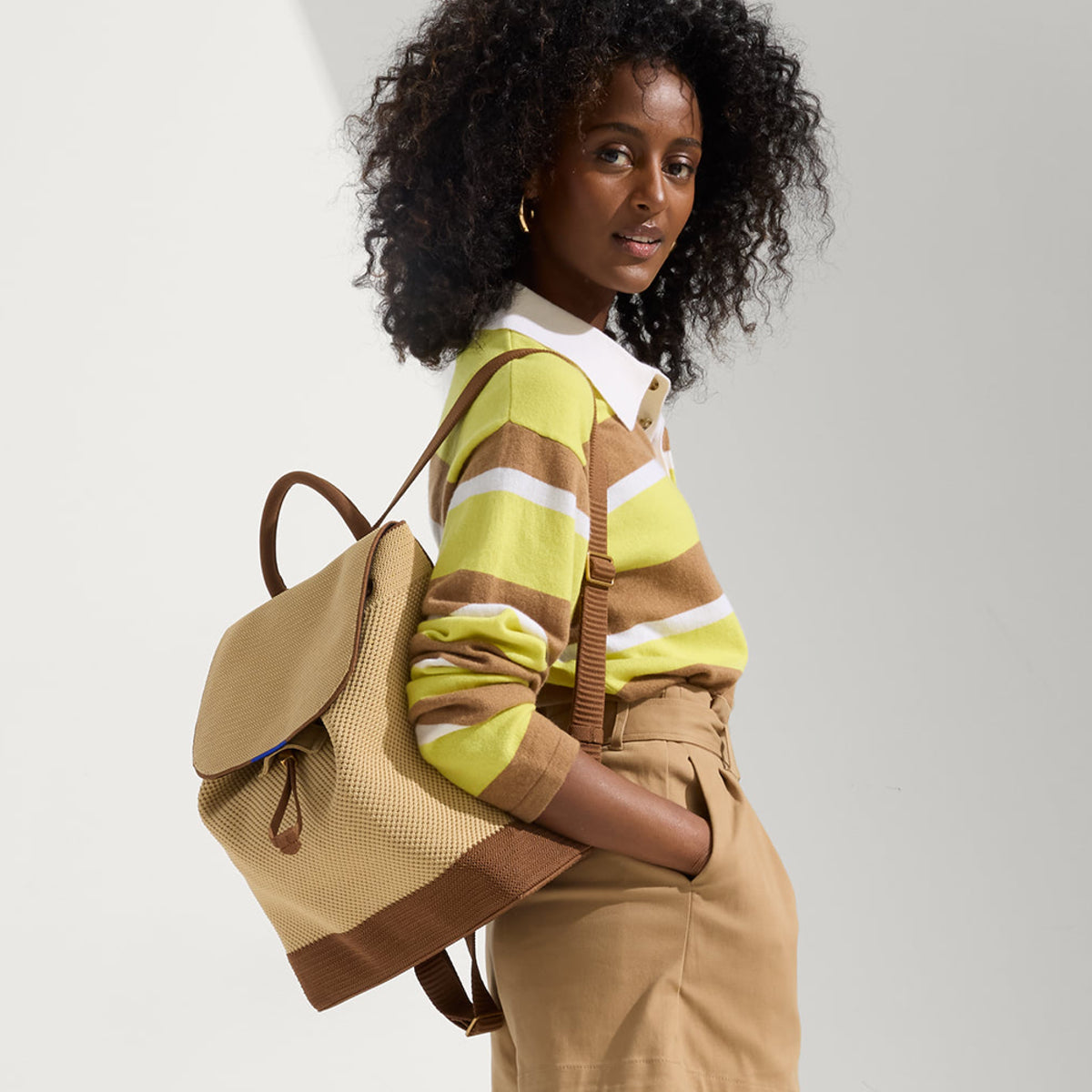 A model wearing The Cinch Backpack.