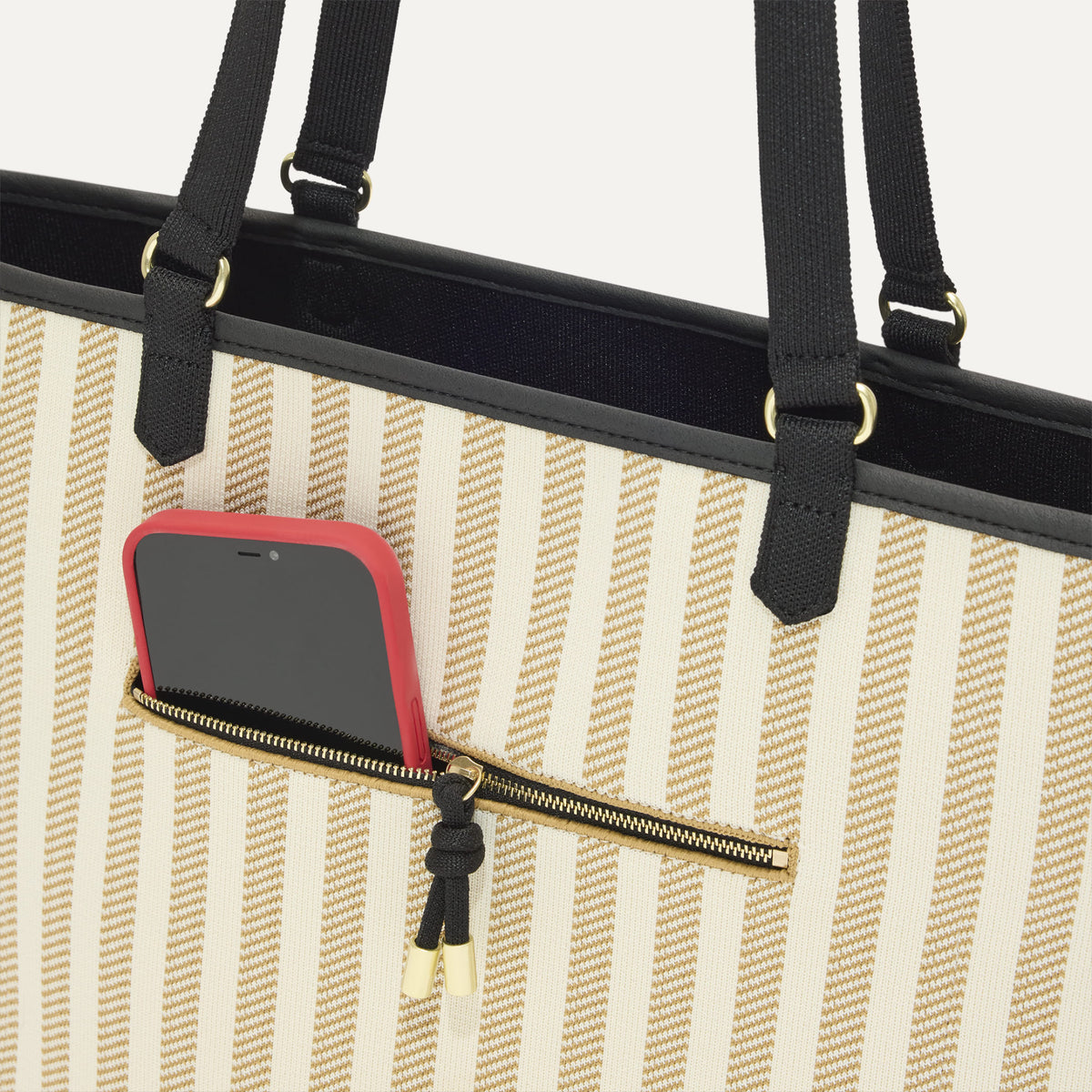 A closeup of The Two-Way Tote in Shadow, focusing on the exterior zip pocket.