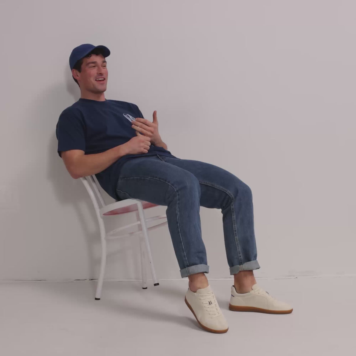 Model walking in The RS01 Sneaker in Bone and showing different angles of the shoes. 