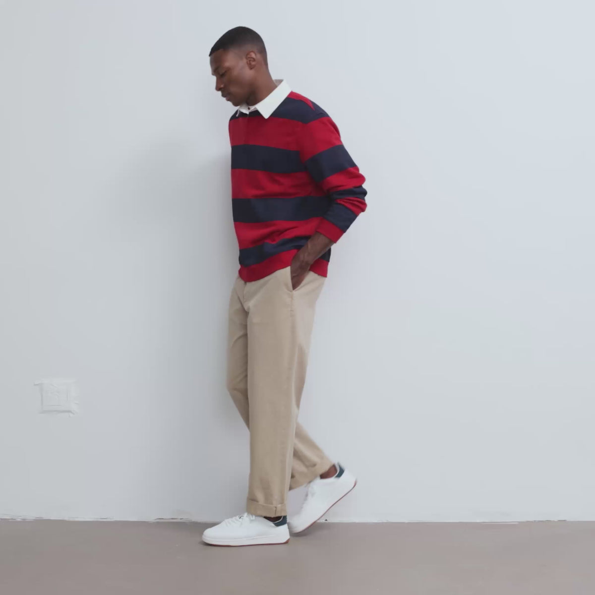 Model wearing The Men's Court Sneaker in Turf and showing different angles of the shoe.